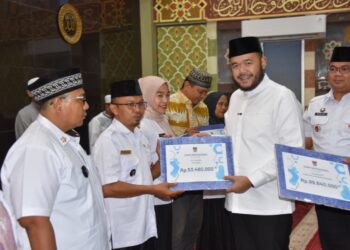 Usai menunaikan shalat Subuh berjamaah di Masjid Raya Andalas, Wali Kota Padang Fadly Amran menyerahkan dana operasional RT/RW Kecamatan Padang Timur Triwulan III, Rabu (22/10).(Foto: Ist)