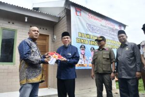 Wakil Wali Kota Padang, Maigus Nasir, menyerahkan kunci Hunian Tetap (Huntap) Mandiri bagi warga terdampak bencana hidrometeorologi di Kampung Tanjung, Kecamatan Kuranji, Jumat (10/7)