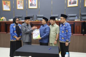 Ketua DPRD Kota Padang Muharlion bersalaman dengan Wawako Padang Maigus Nasir usai menandatangani pengesahan APBD perubahan tahun anggaran 2026